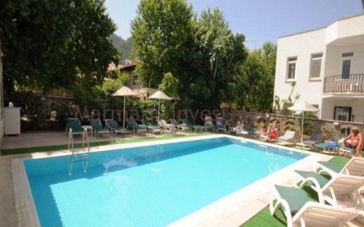 The 21 room hotel for sale with its outdoor restaurant and bar in Icmeler