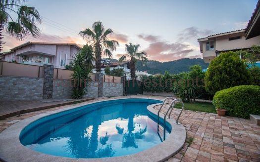 A luxury vacation home for sale in Marmaris Icmeler with a private swimming pool and garden