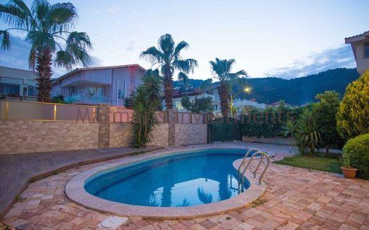 A luxury vacation home for sale in Marmaris Icmeler with a private swimming pool and garden